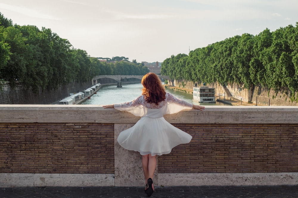 a person leaning against a brick wall