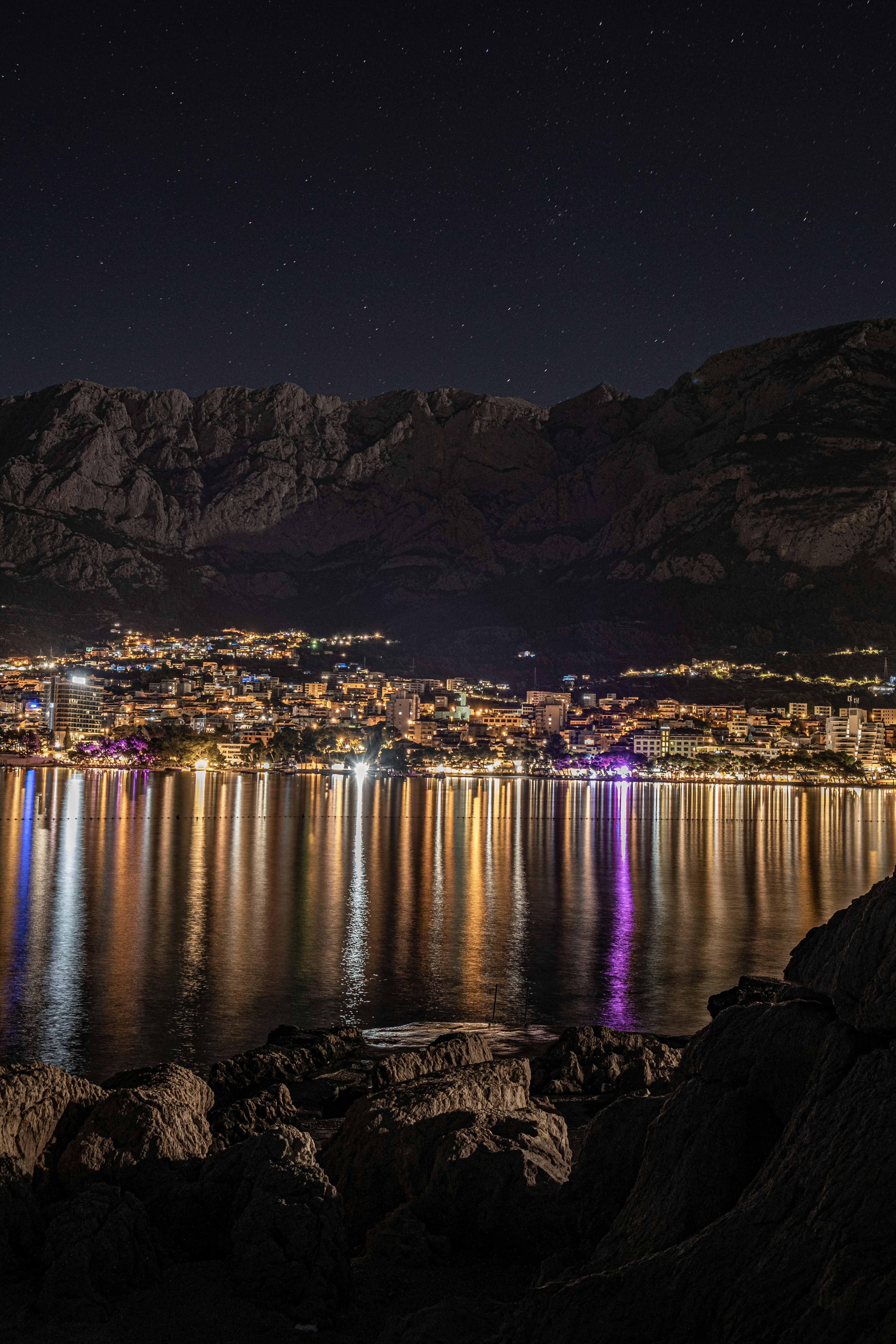 a city next to a body of water at night