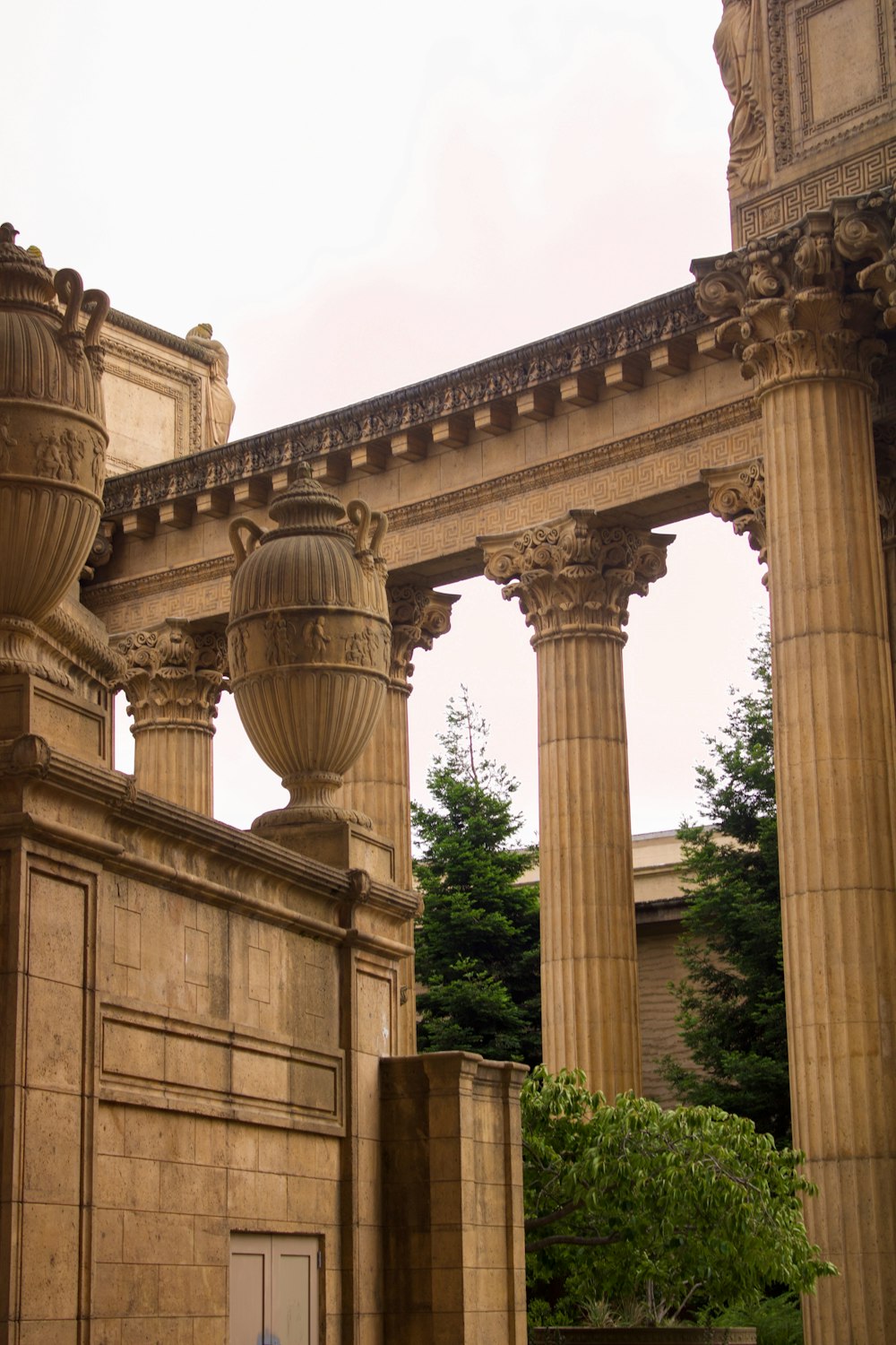 a building with pillars and a tree