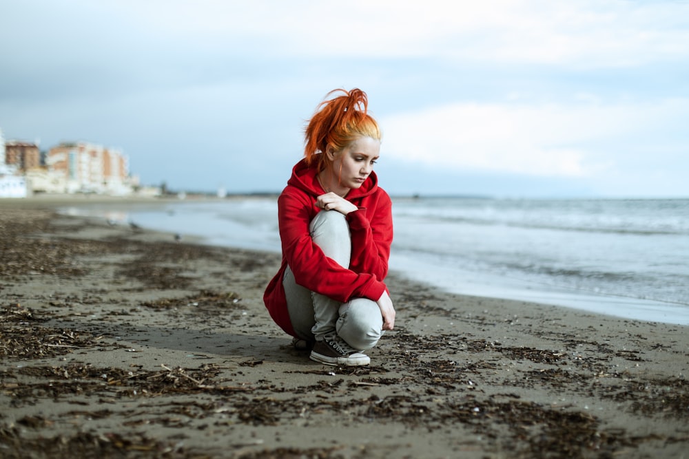 a person kneeling on a beach