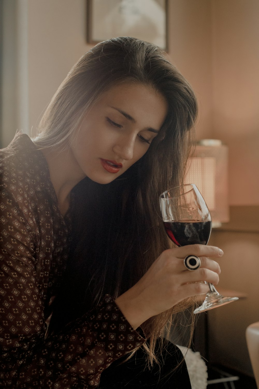 a woman holding a glass of wine