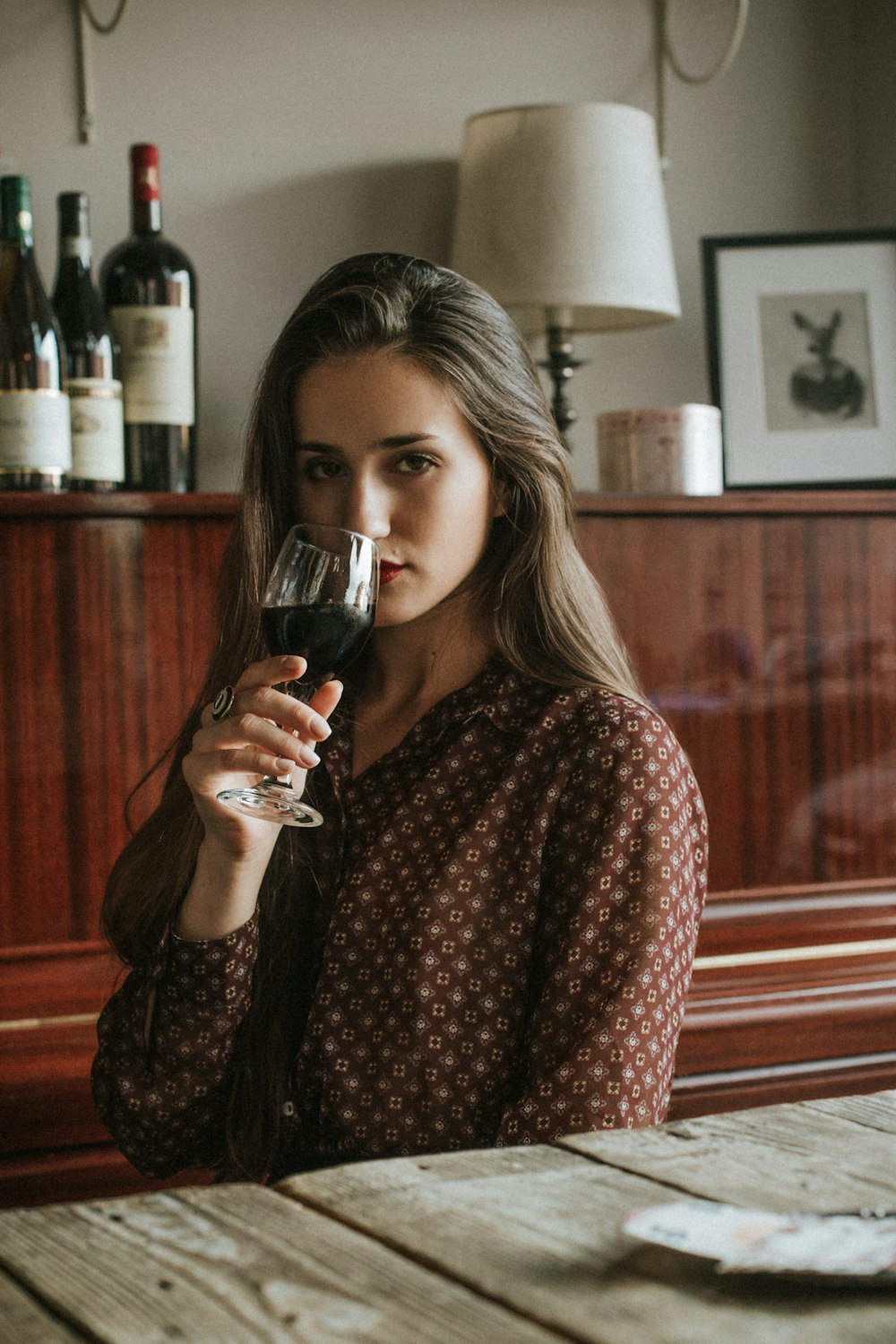 a woman holding a glass of wine