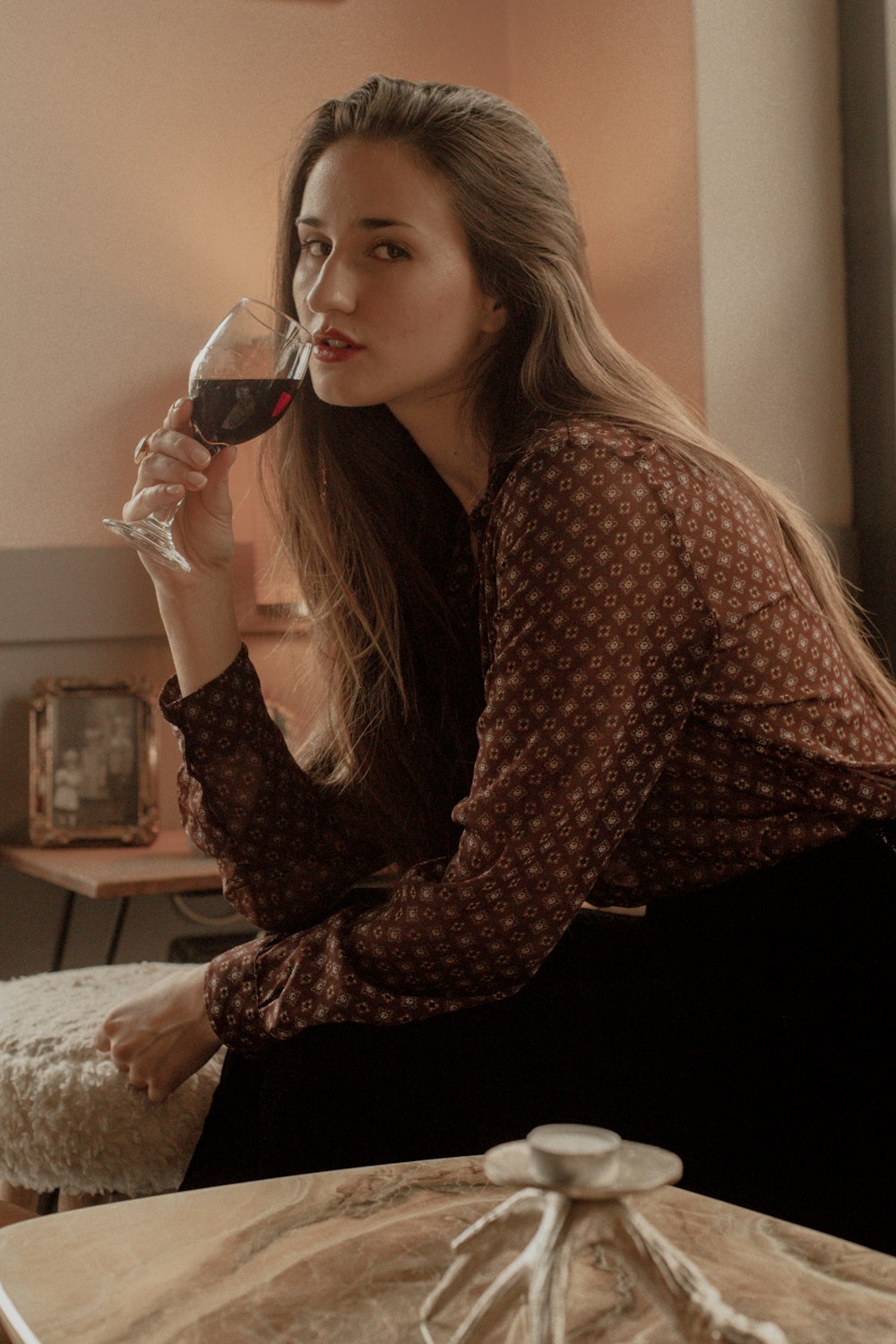 a woman drinking a glass of wine