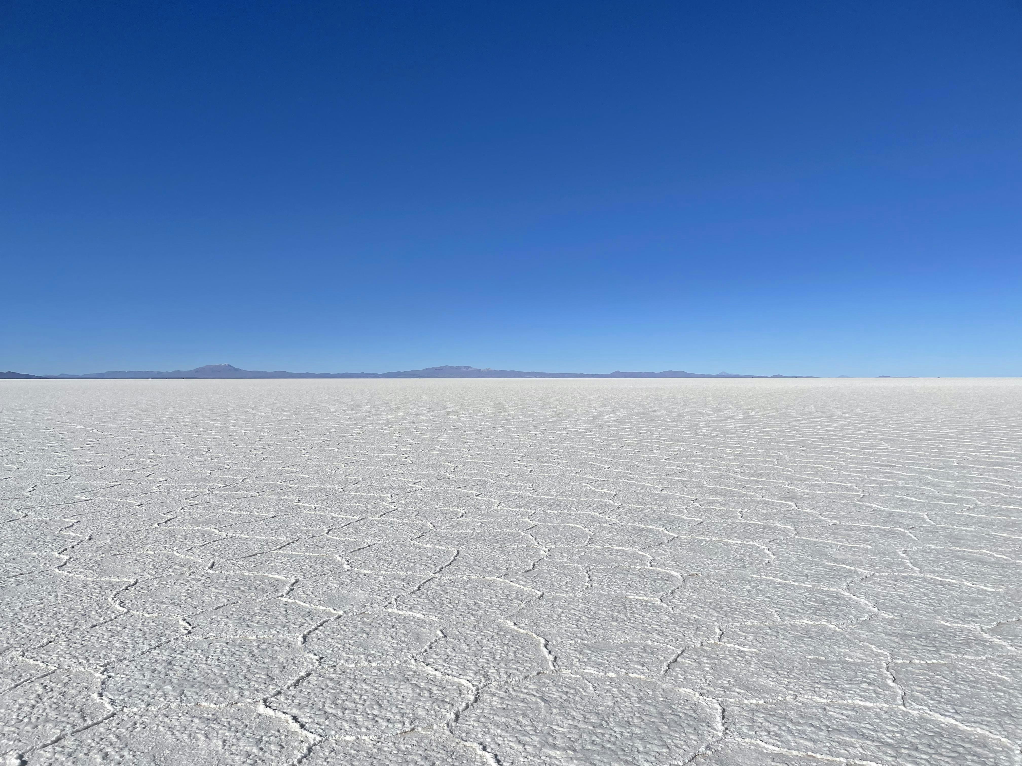a large flat area with mountains in the distance