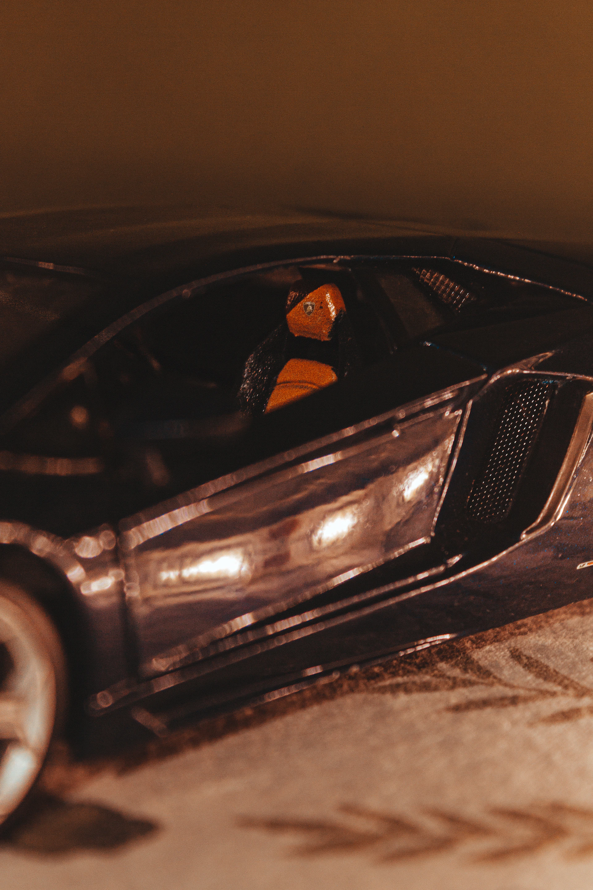 A behind-the-scenes moment showing a friendly instructor guiding a student in a sleek, futuristic car, framed by deep ripe crimson details inside the vehicle.
