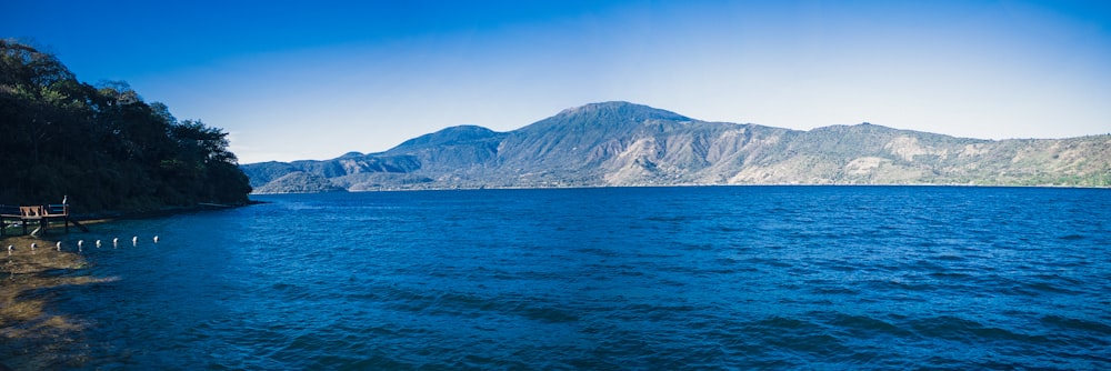 a body of water with mountains in the background