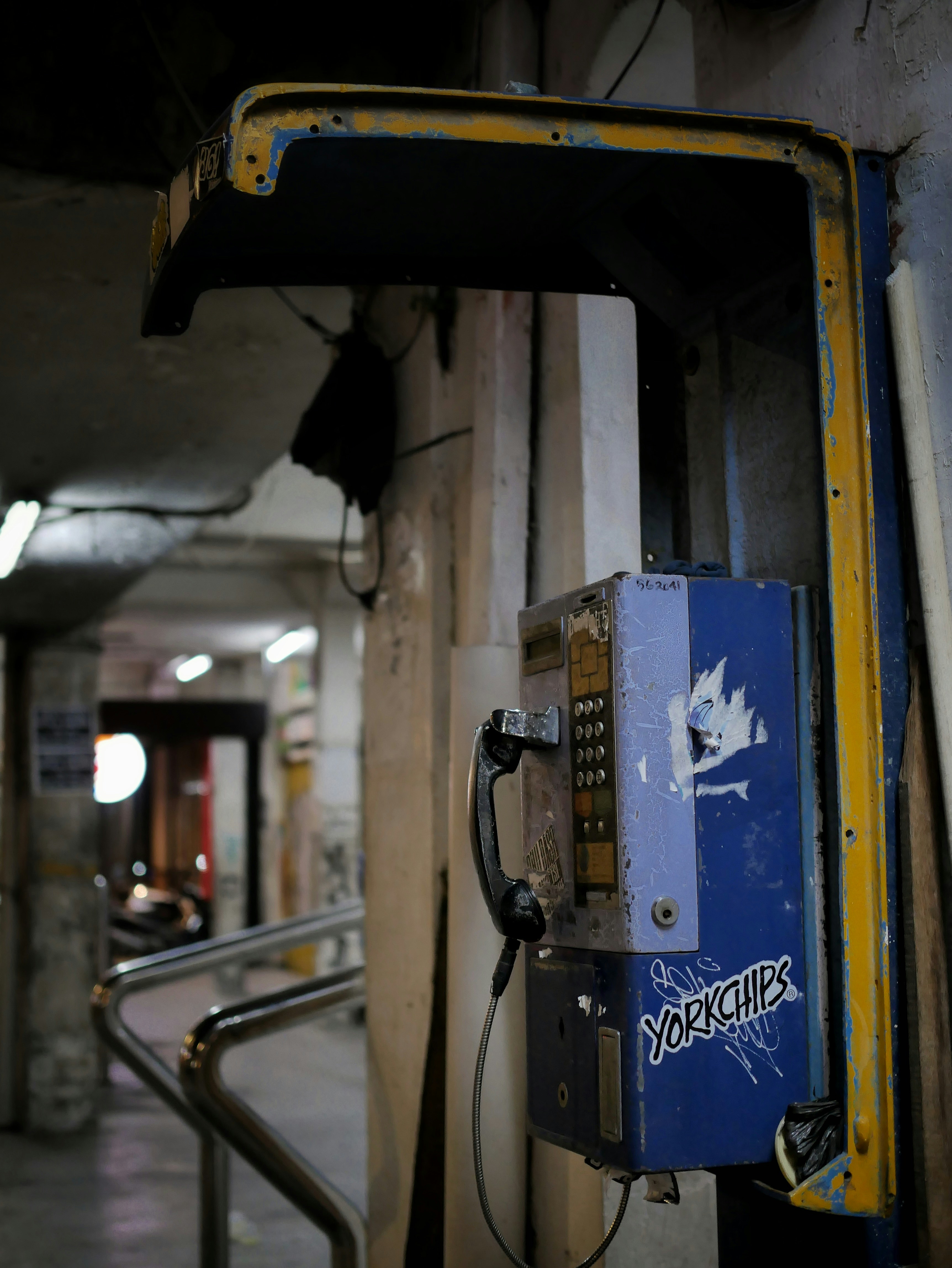 a blue and yellow telephone booth