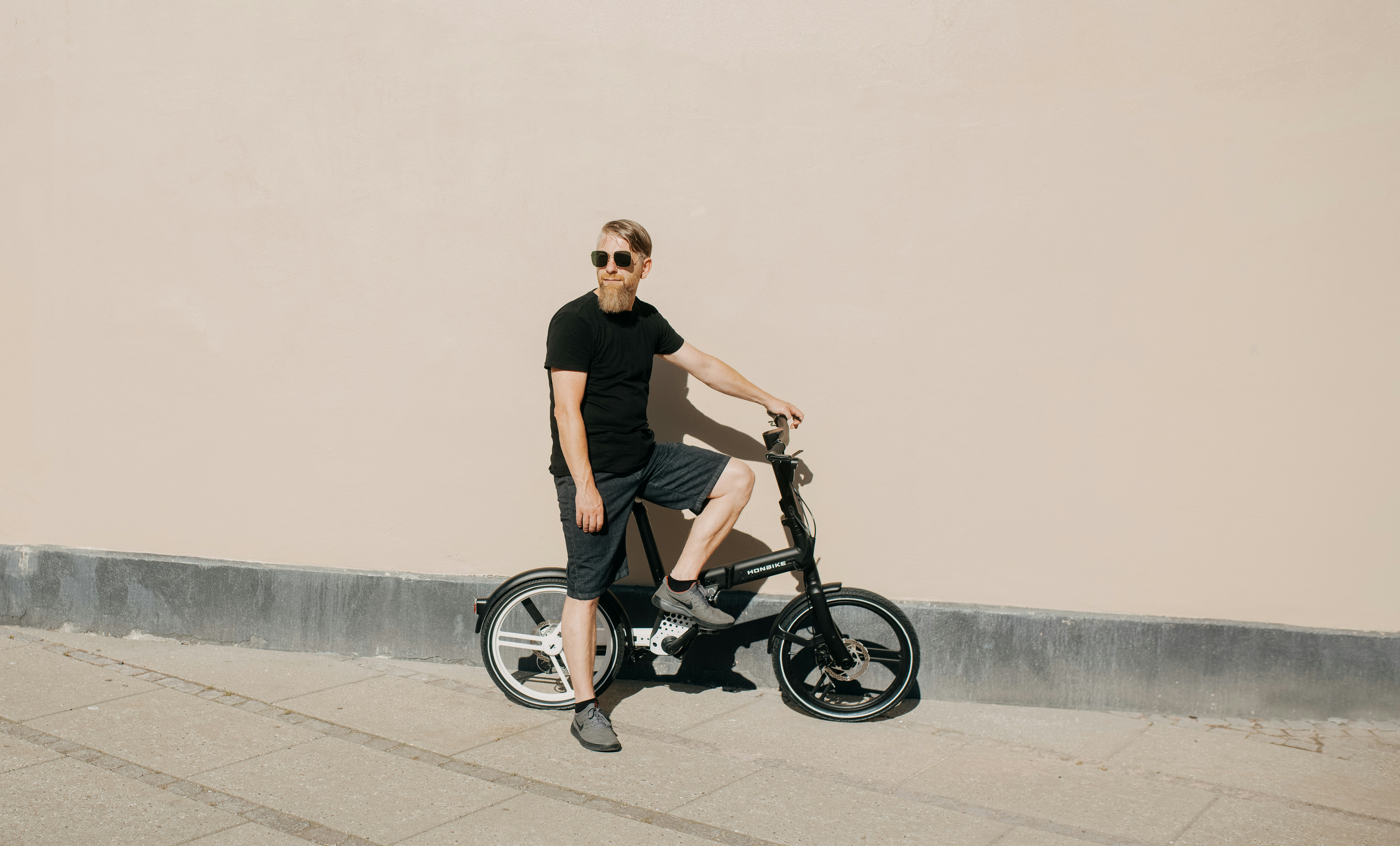 Tom O'Brien, male cyclist with light beard and blue eyes, casual outdoor portrait