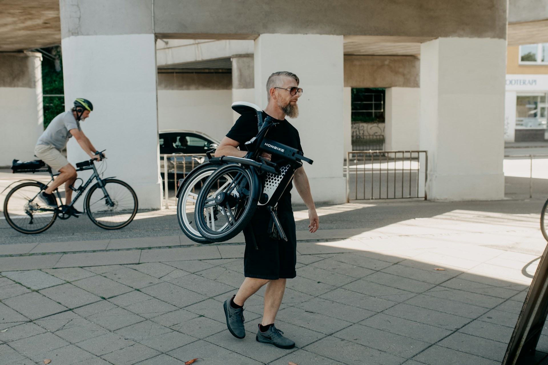 a person in a black dress walking with a person in a black dress