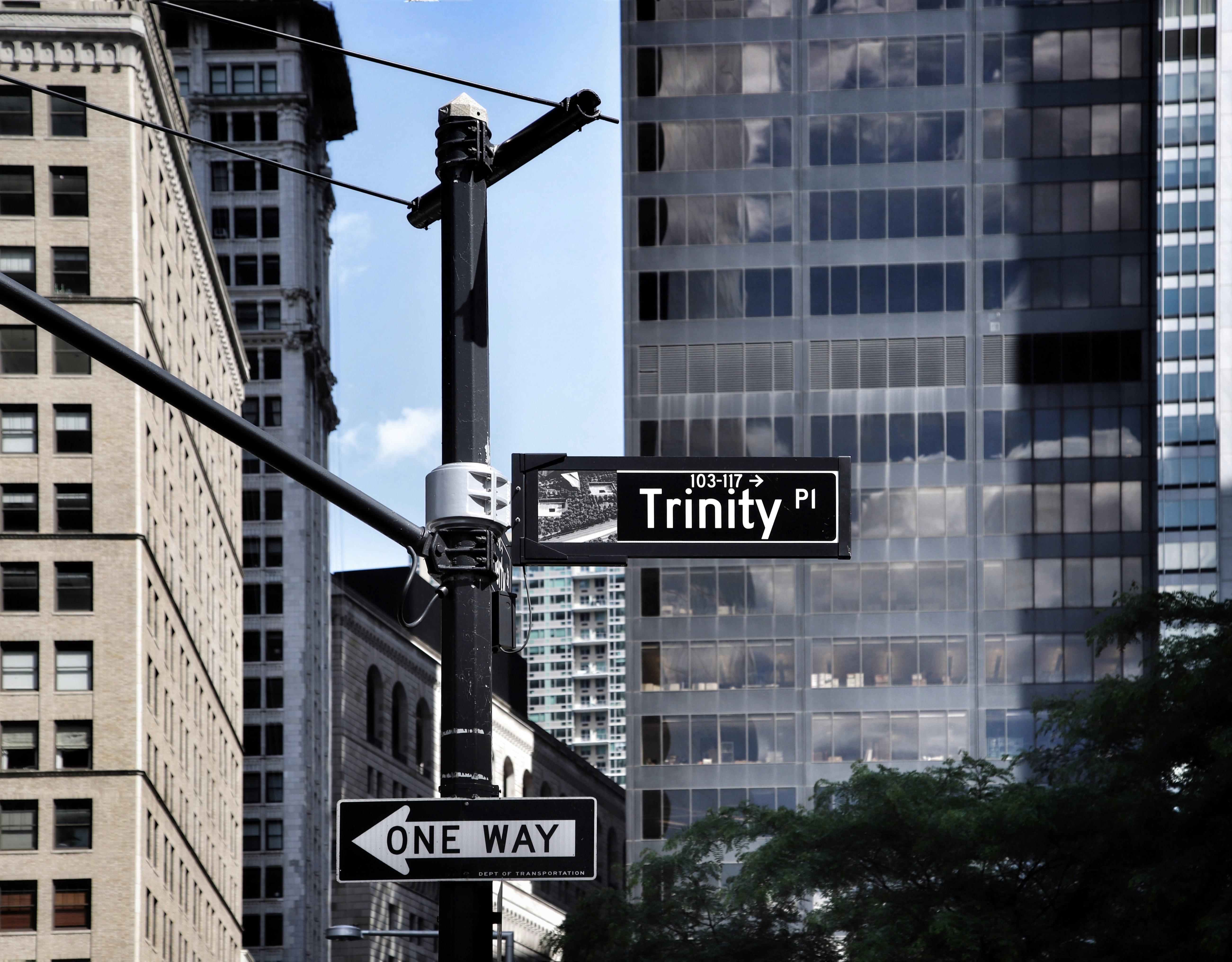 a street sign in front of a skyscraper, 