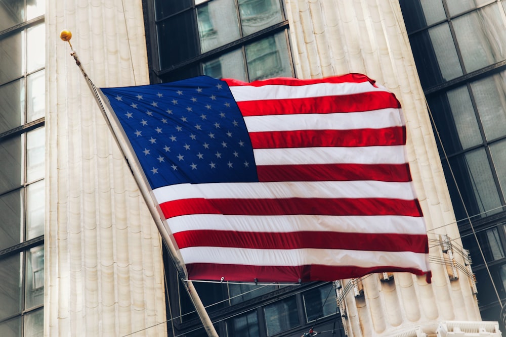 a flag flying in front of a building