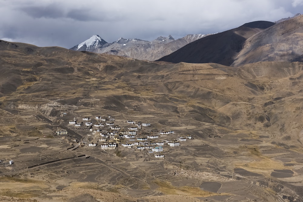 a valley between mountains with buildings