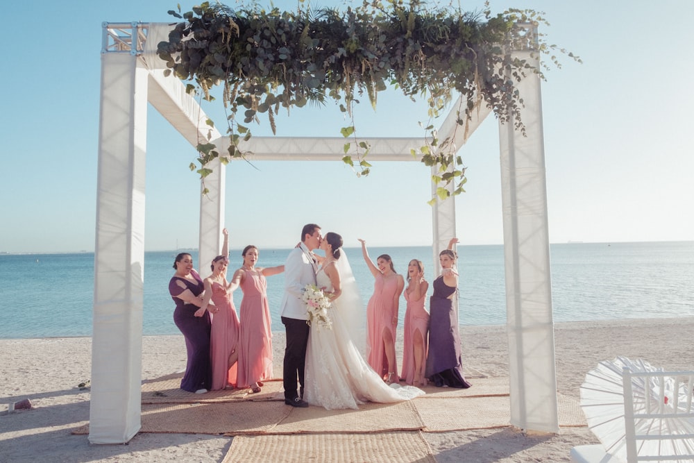 a group of people posing for a photo under a gazebo