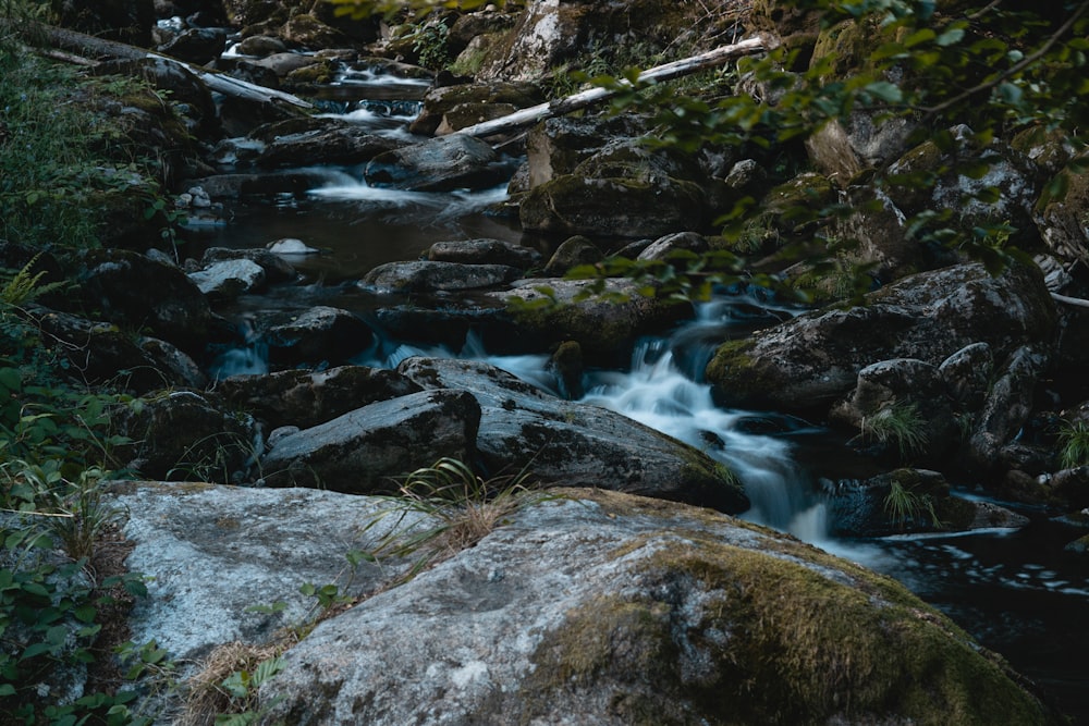a stream of water flowing through rocks