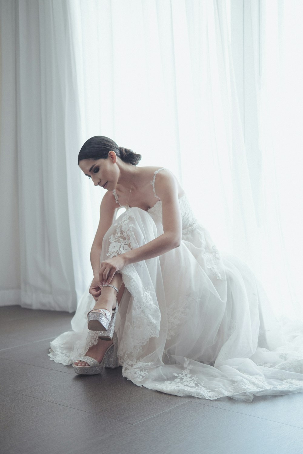 a man in a wedding dress sitting on the floor