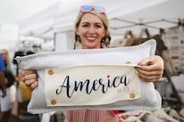 A smiling customer wearing a pro-Trump t-shirt while holding a coffee mug with a patriotic design.