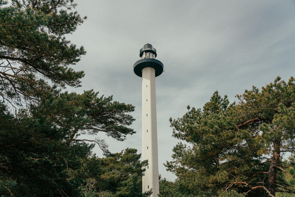 a tall white tower with a light house on top