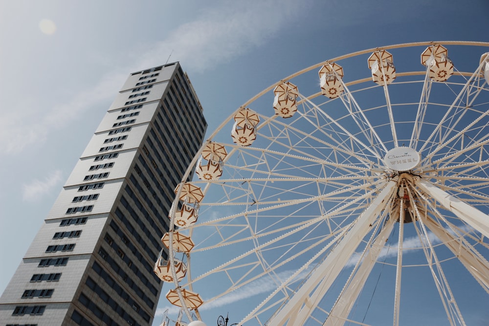 a tall building with a ferris wheel