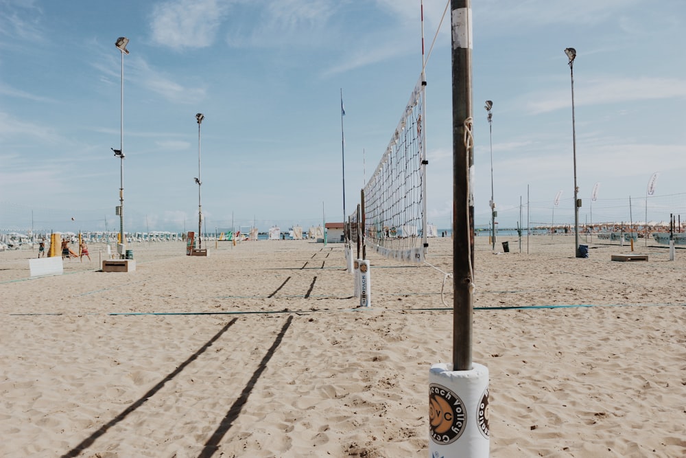 a group of metal poles on a beach