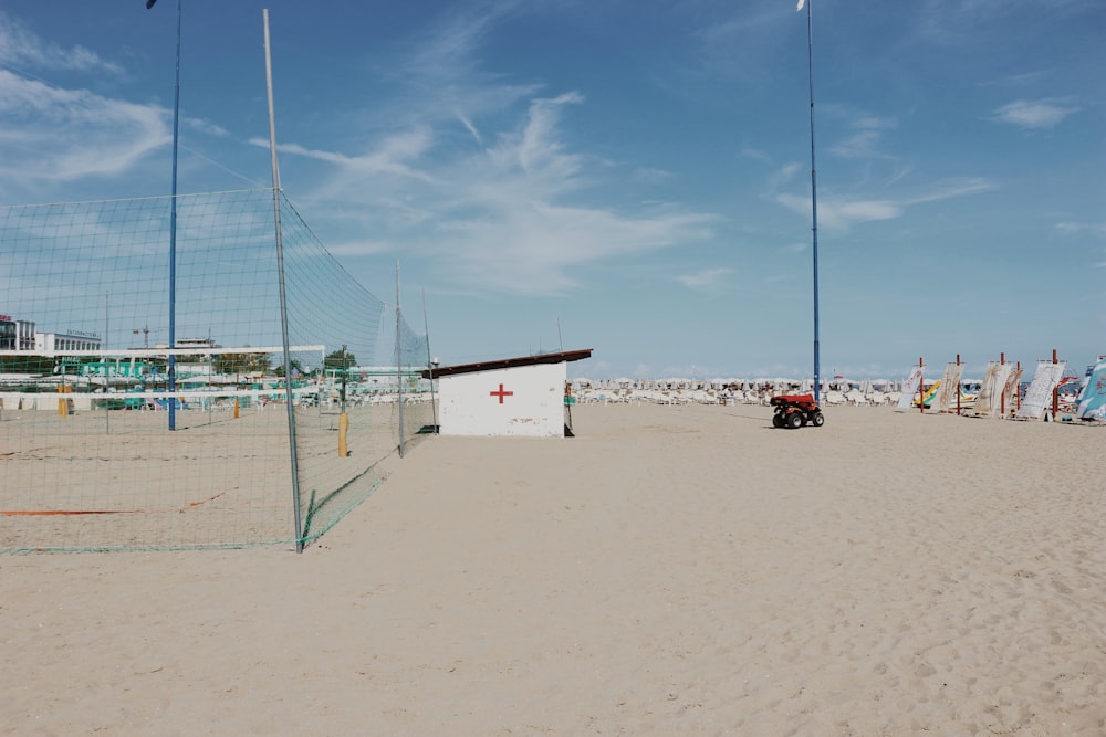 a sandy beach with a sign