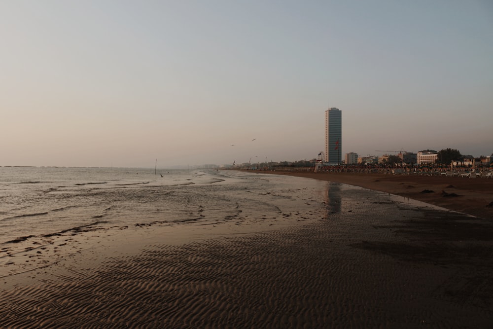 a beach with buildings in the background