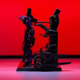 A model of a futuristic robot with sleek design and intricate details stands on a platform against a bold red background. The robot features purple and green accents and appears to be equipped with mechanical components and armor.