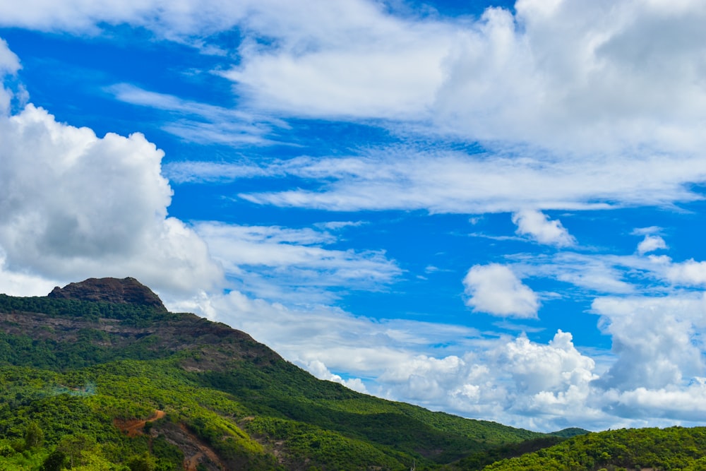 a landscape with hills and clouds