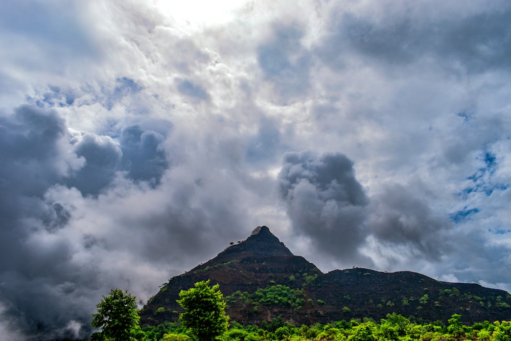 a mountain with clouds above it