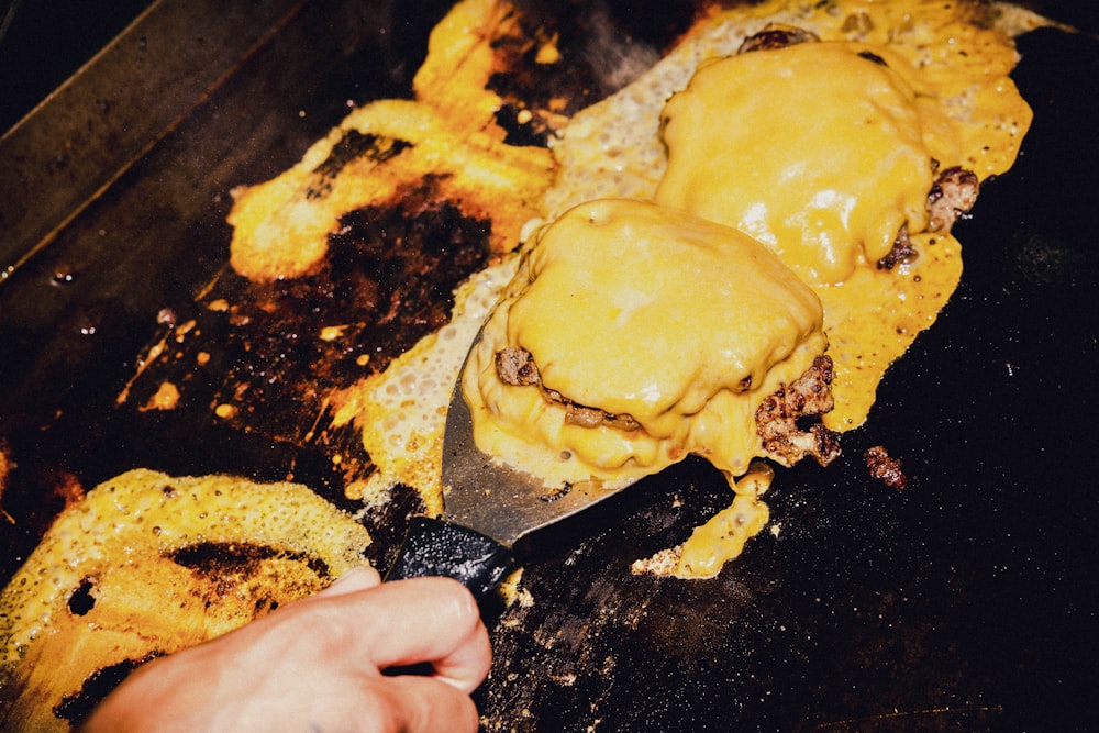 a person cooking food on a grill