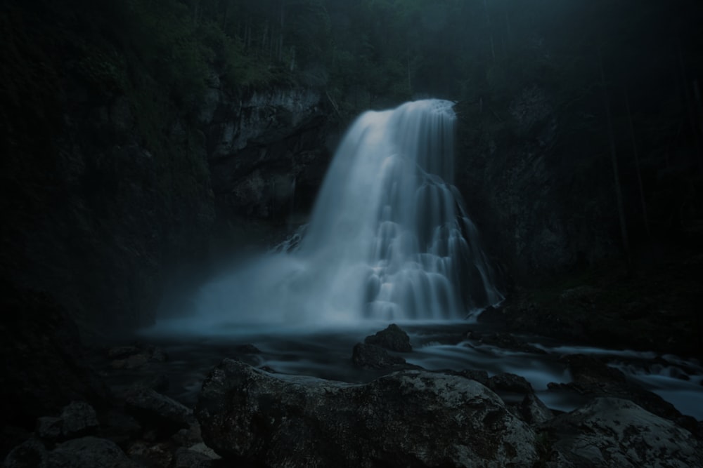 a waterfall in a dark place