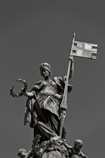 a statue of a person holding a cross
