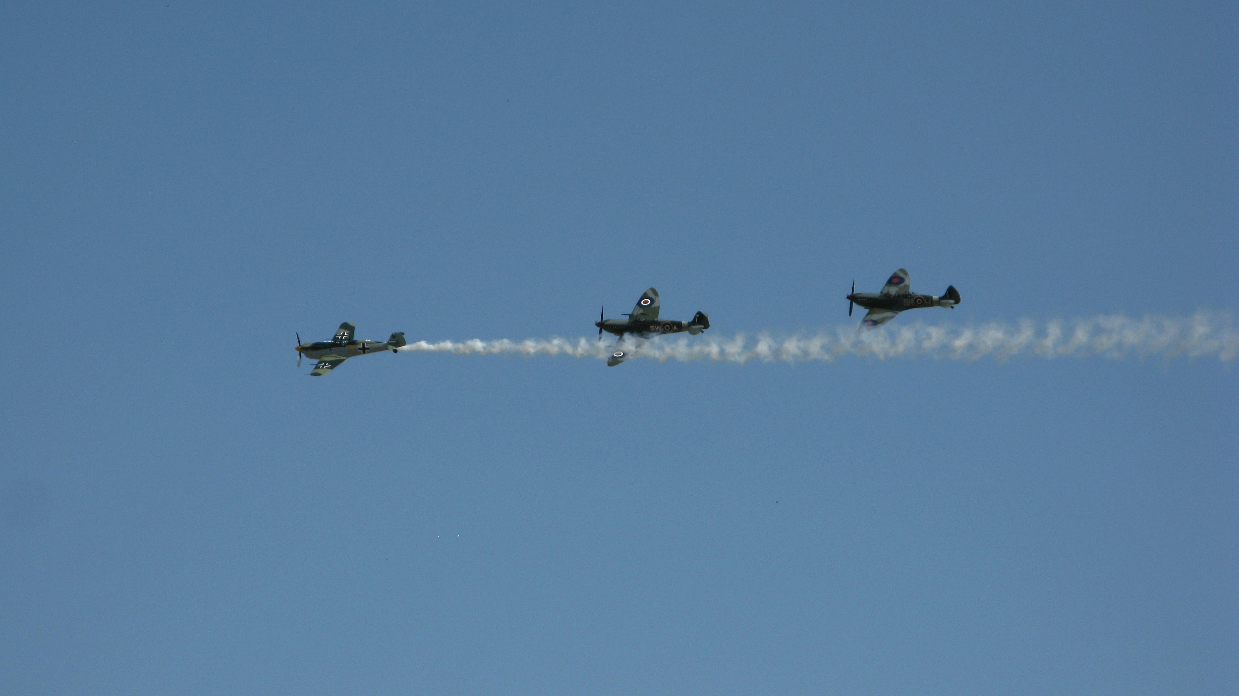 a group of planes fly through the air