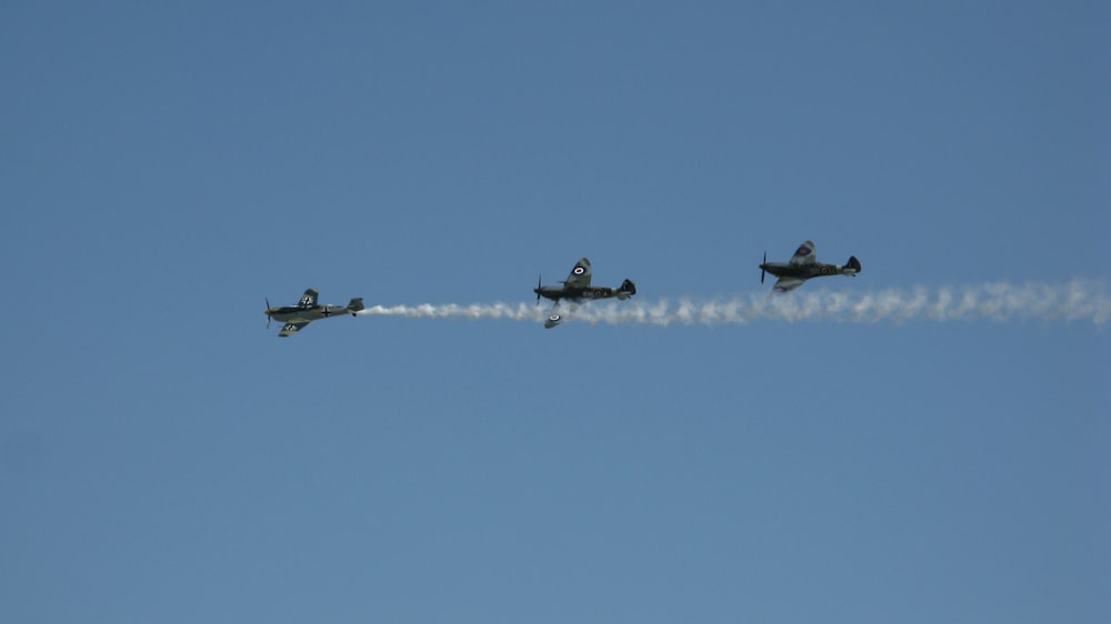 a group of planes fly through the air