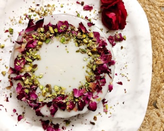 Delicate rosewater and pistachio Turkish delight cubes arranged neatly on a decorative plate.