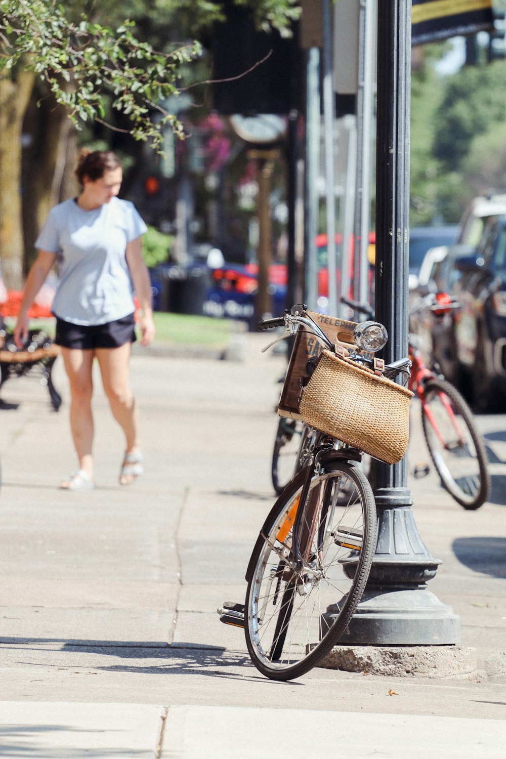 a person walking down the sidewalk with a bicycle