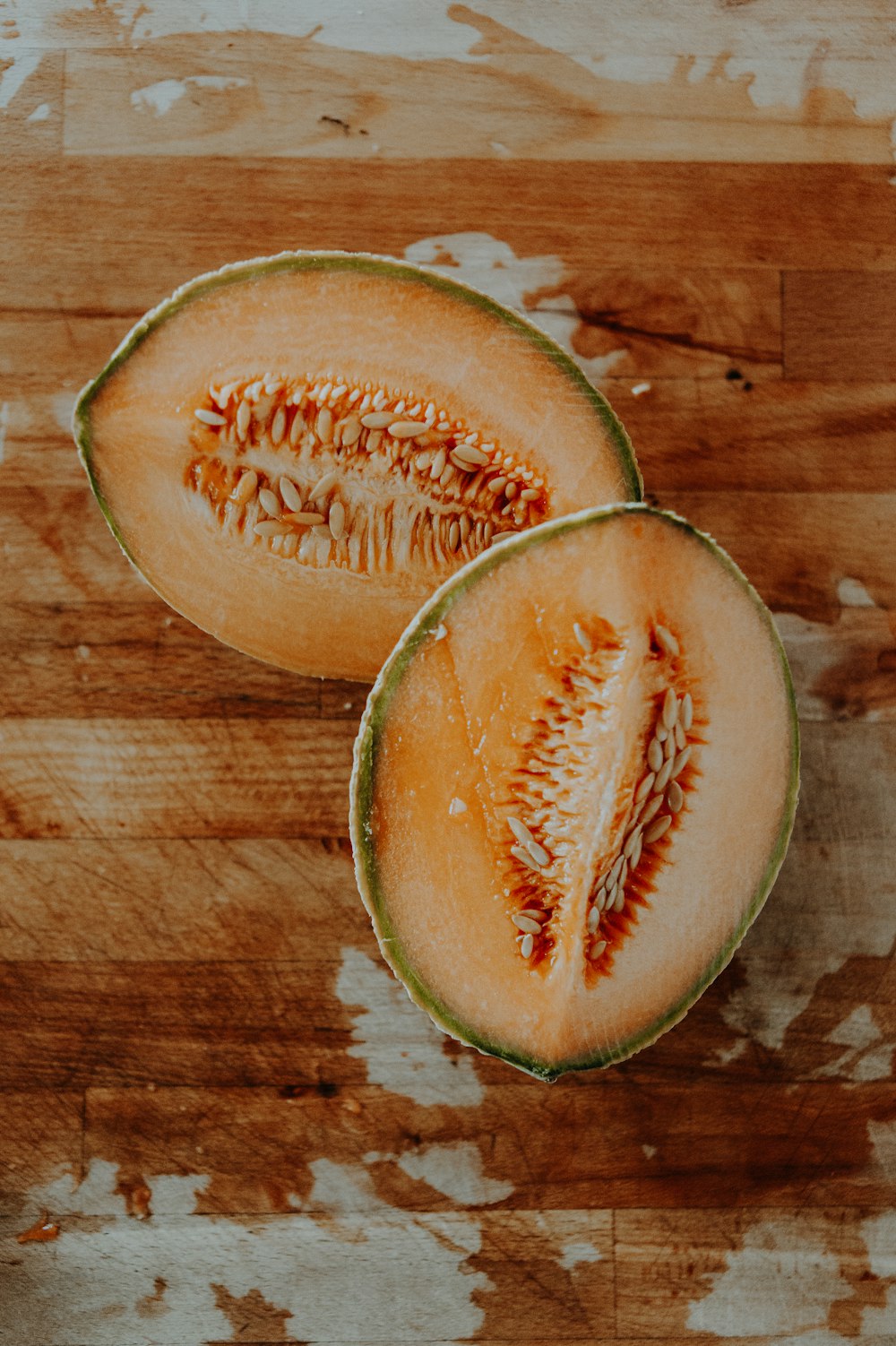 a sliced avocado on a wooden surface