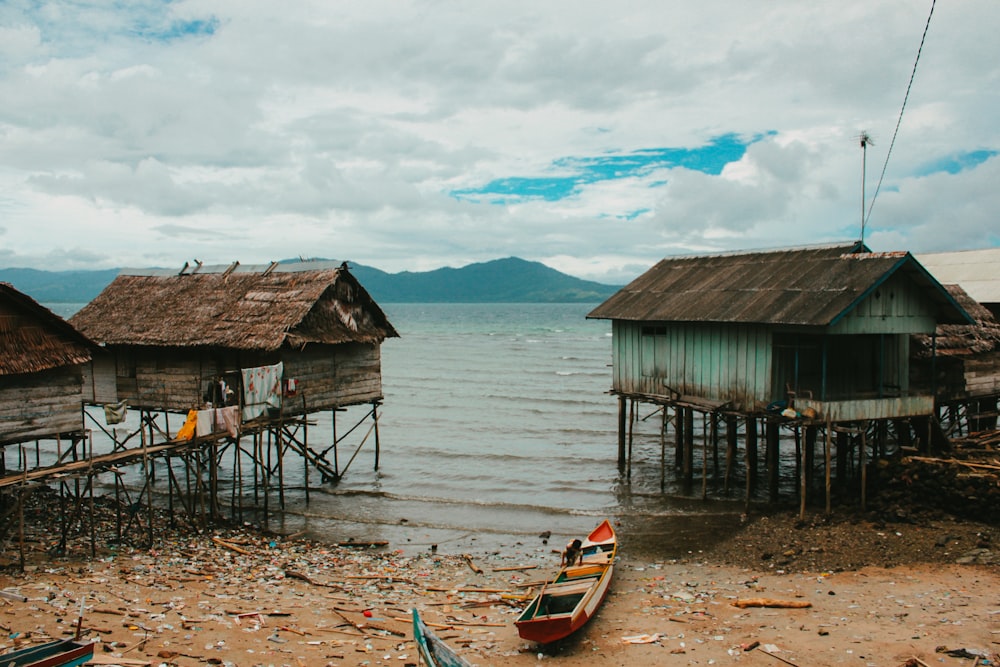 a boat sits on the shore of a lake