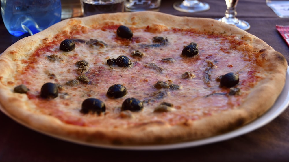 a pizza with olives on it