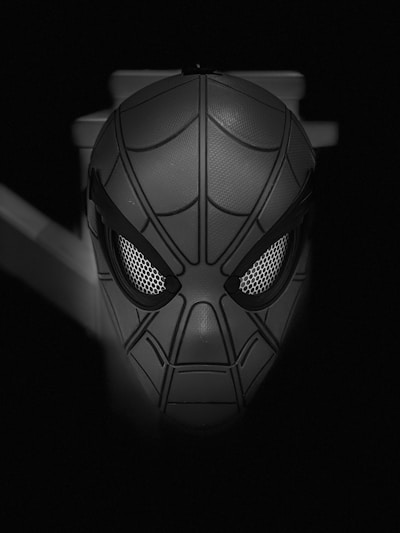 A dynamic close-up of Spider-Man's mask highlighting the intricate web pattern and vibrant red and blue colors.