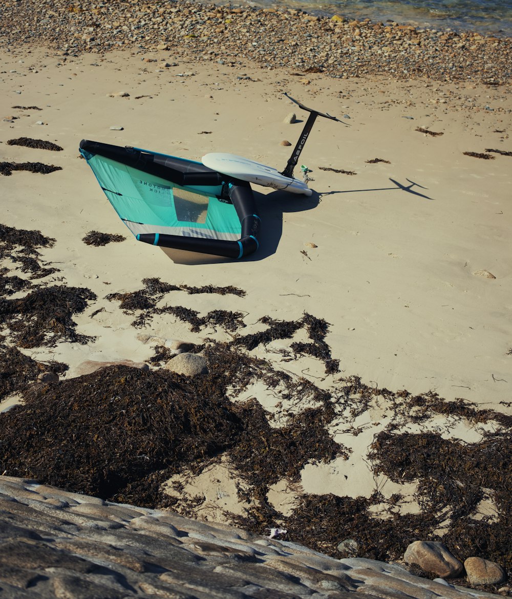 a small blue boat on a beach