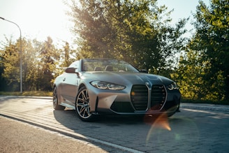 a silver sports car on a road