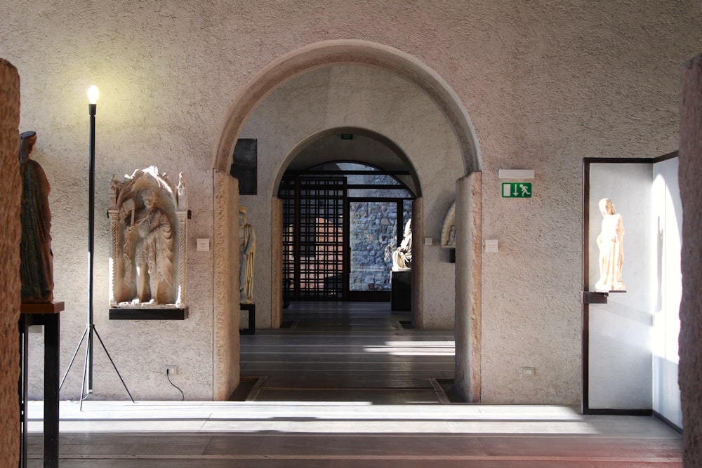 a hallway with statues