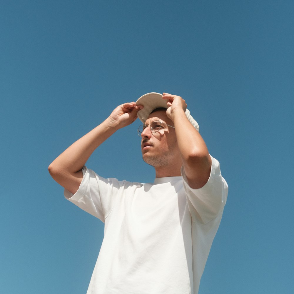 a person wearing a hat and holding the hands up