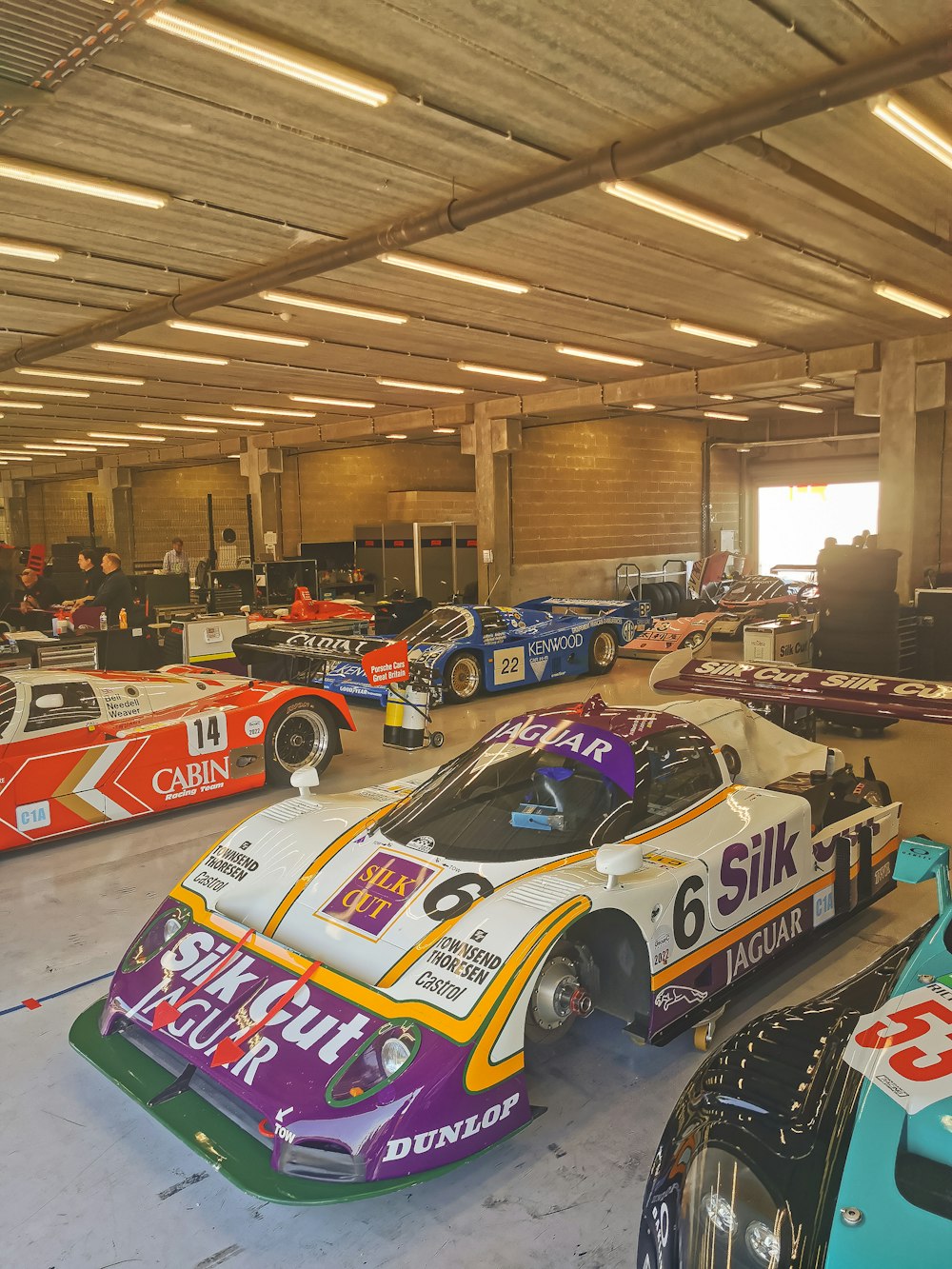 a group of race cars in a garage