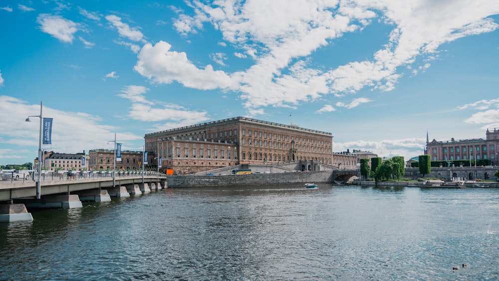 a body of water with a bridge and buildings in the background