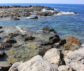 a rocky beach with waves crashing