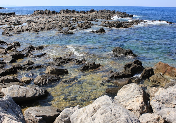 a rocky beach with waves crashing