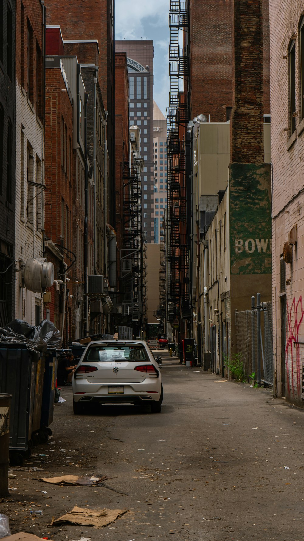 a car parked in a alley between buildings
