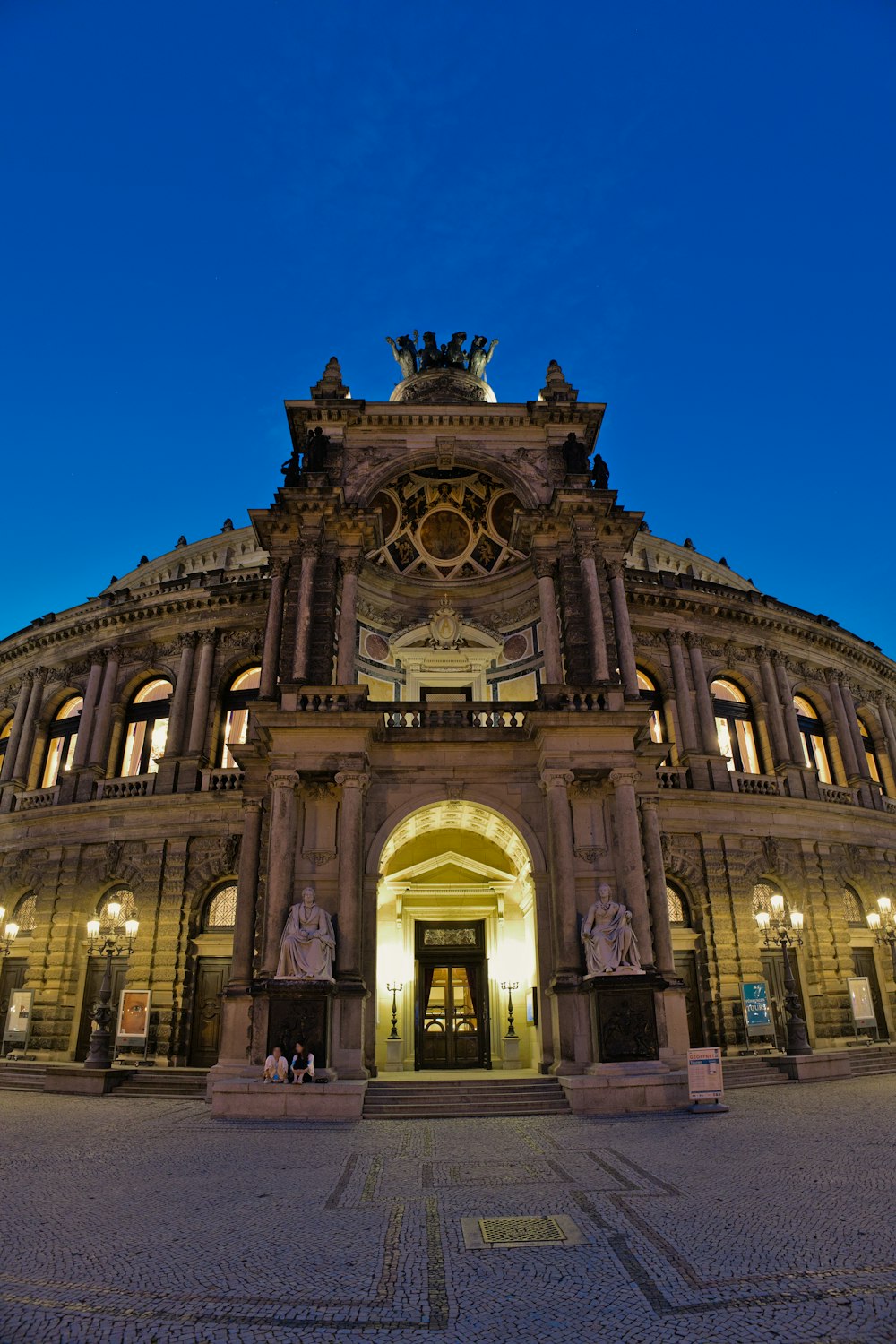 a large ornate building with statues with Semperoper in the background