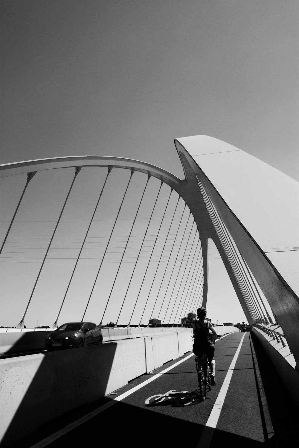 a person riding a bicycle on a bridge